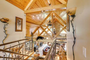 A spacious loft-style room with high ceilings, exposed wooden beams, and a cozy seating area. - Hornersville Vacation Rental w/ Private Pond! (Hornersville)