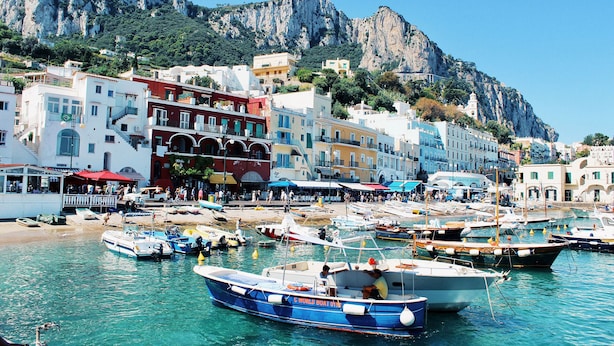 A coastal town with boats docked at the harbor, buildings with balconies, and a mountainous backdrop. - Modern Villa with Pool and Breathtaking Views on the Enchanting Amalfi Coast! (Amalfi)