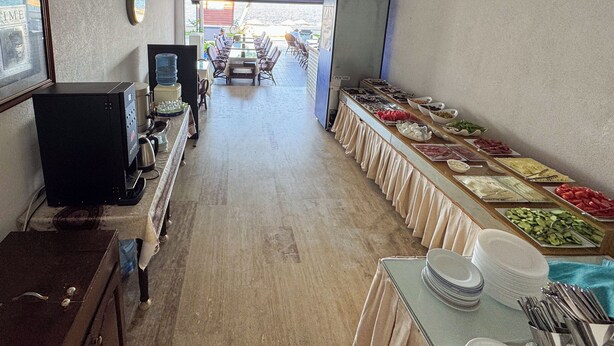 A buffet area with a variety of food options, a water dispenser, and a coffee machine. - Er-Öz Hotel & Restaurant (Fethiye)