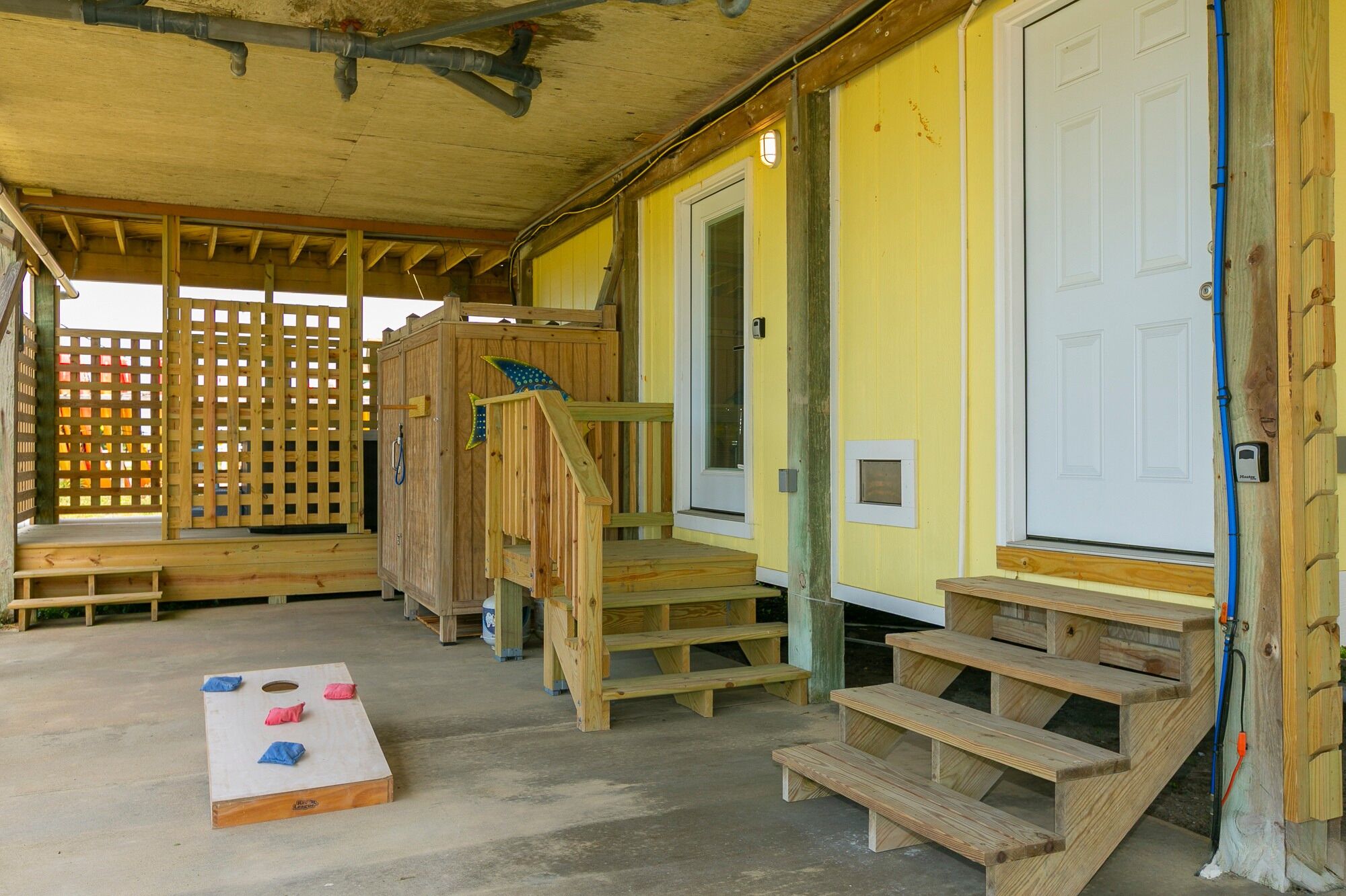 A wooden structure with a porch, a door, and a bench.