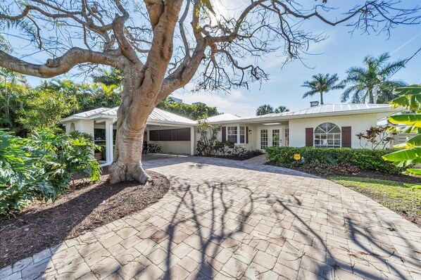 A two-story house with a paved driveway leading to a covered garage. - 3 Bed, 3 Bath, Pool with Hot tub with water view (Sarasota)