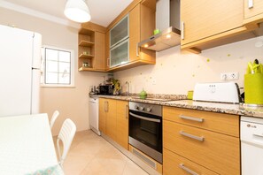 Enjoy meals in the well-lit kitchen with oven and dishwasher, and adjacent dining area.