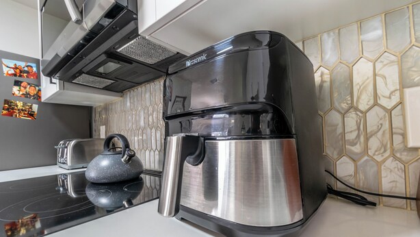 A modern kitchen with a stainless steel coffee maker, a kettle, and a toaster on the counter. - Cozy 2BD Near Ft. Myers Beach (Ft. Myers)