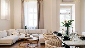 Deluxe Apartment, Garden View | Living room | Flat-screen TV