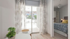 A modern bedroom with a bed, a bedside table, and a potted plant. - Ocean Paradise 2 la Tejita (Intero appartamento, due camere e un bagno) (Granadilla de Abona)