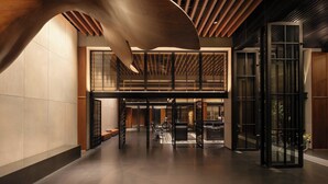 A spacious lobby with a high ceiling, modern design elements, and a seating area.