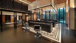 A modern interior with a bar area, seating, and a large window offering a view of the outdoors.