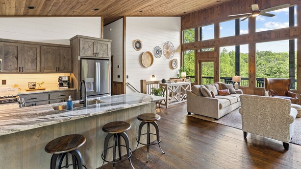 A spacious kitchen with a large island, wooden cabinets, and a view of the outdoors. - Brand NEW Luxury Chalet! Summer Sale! (Epworth)
