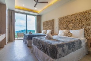 A hotel room with two beds, a large window, and a view of the landscape.