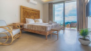 Une chambre moderne avec un grand lit, une tête de lit en bois, une table de chevet, une chaise, un banc et une plante en pot.