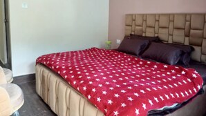 A bedroom with a bed, a headboard, and a nightstand.