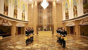 A grand hall with a marble floor and a central chandelier. - Huatai Hotel (Tianmen)