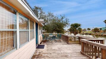 Enjoy dining or socializing on the deck with a table and chairs, overlooking the waterfront.