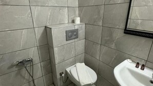 A bathroom with a toilet, a sink, and a shower. - BODRUM LOTUS LINE HOTEL (Bodrum)