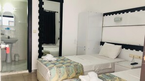 A hotel room with two beds, a bathroom, and a wardrobe. - BODRUM LOTUS LINE HOTEL (Bodrum)