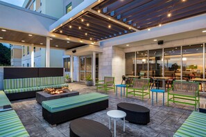 An outdoor patio area with seating, a fire pit, and a covered dining area. - Home2 Suites By Hilton Virginia Beach Princess Anne (Virginia Beach)