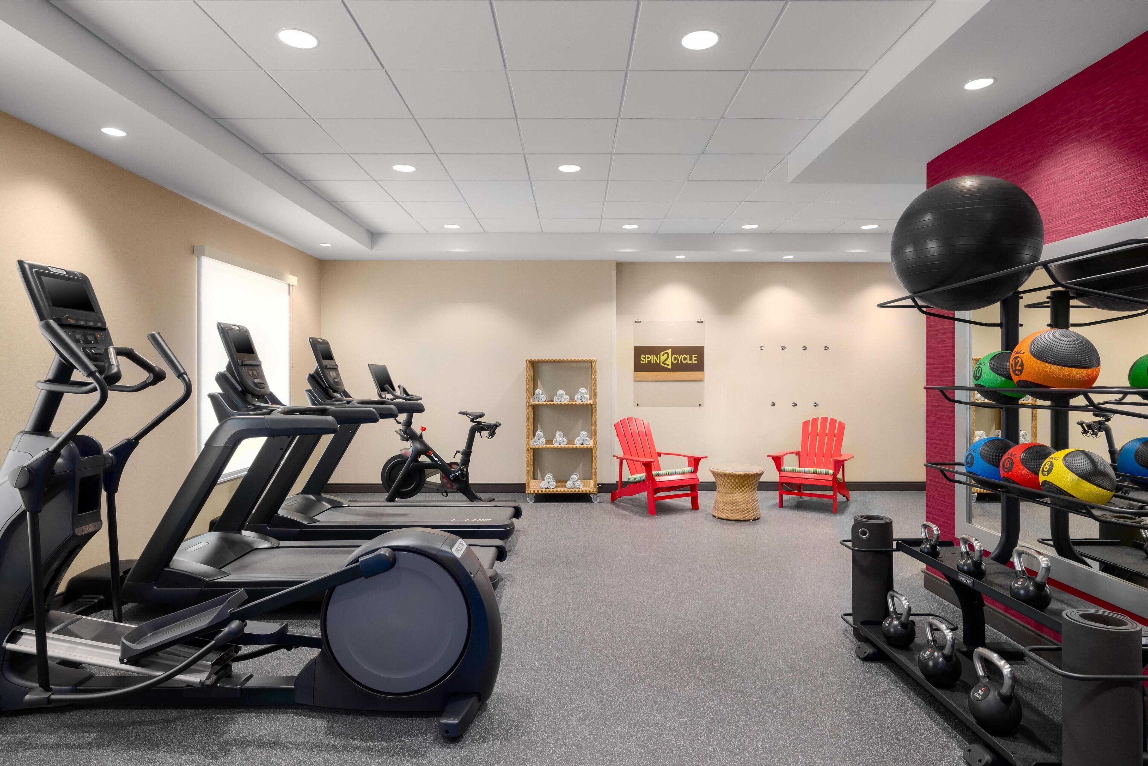 A gym with treadmills, stationary bikes, and various exercise equipment.