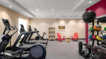A gym with treadmills, stationary bikes, and various exercise equipment.