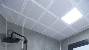 A modern bathroom with a glass shower enclosure, a sink, and a mirror. - Sur Central Hotel (Diyarbakir)