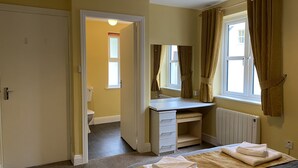 A bedroom with a bed, a desk, a radiator, and a window with curtains. - Cottage 466 - Clifden - sleeps 5 guests  in 3 bedrooms (Clifden)