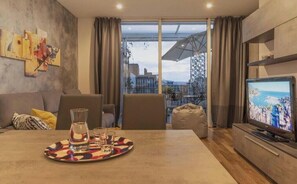 Relax in this urban retreat with a city view, a flat-screen TV, and a coffee table for unwinding.