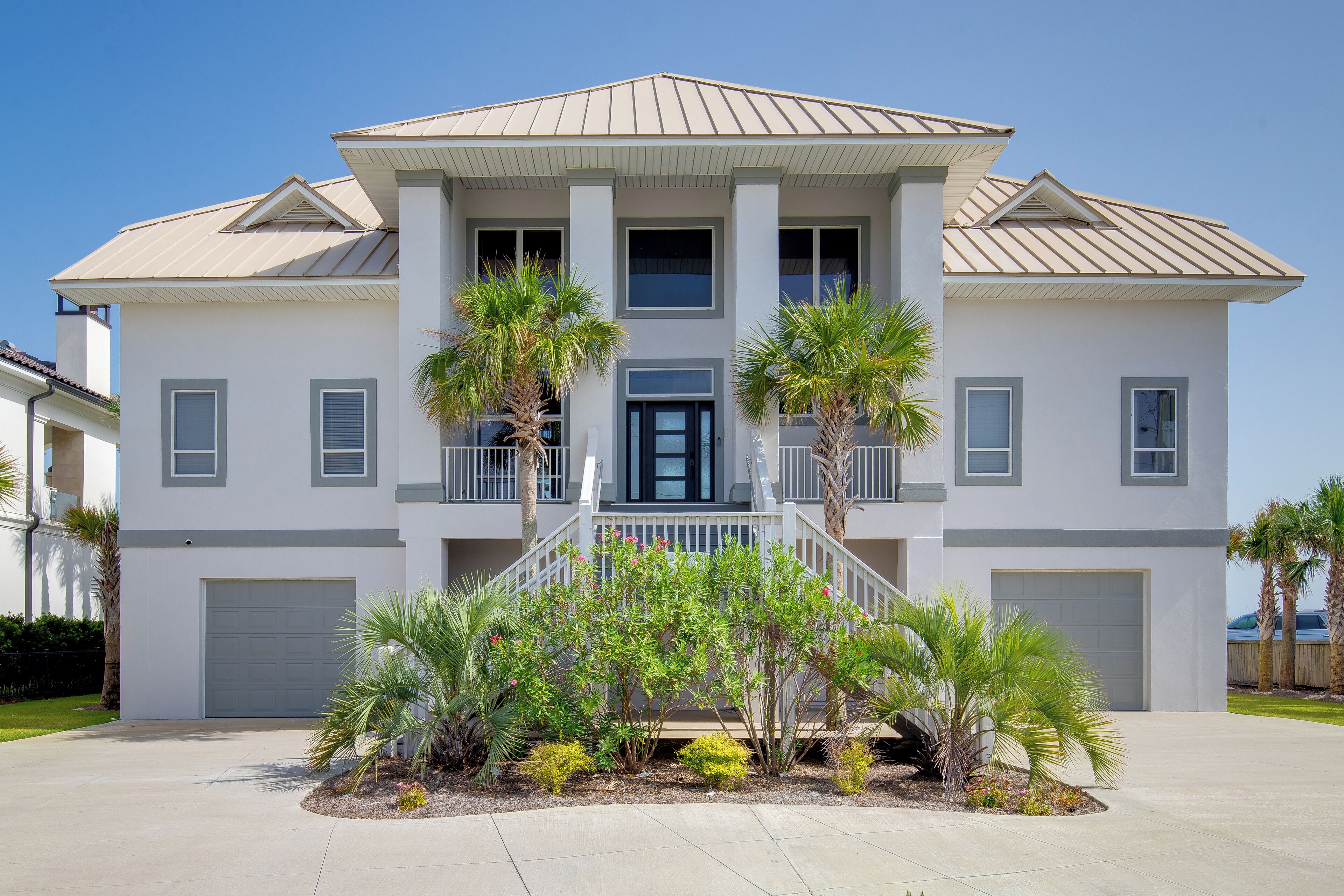 A two-story house with a front porch, a garage, and a well-maintained lawn.