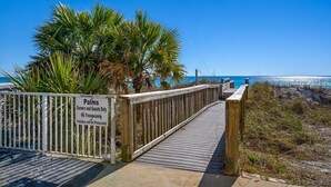 A wooden boardwalk leading to a beach with a sign indicating 'Palms Owners and Guests Only' and 'No Trespassing'. - The Palms #501 (Fort Walton Beach)