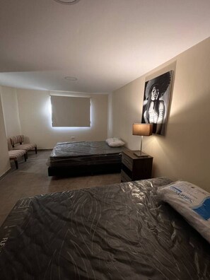 Cozy retreat with a single bed, bedside table, and comfortable seating area.