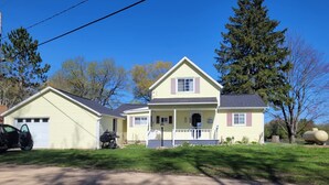 A two-story house with a front porch, a garage, and a driveway. - Lake Front on Little Clear Lake- Comfort Resort (Prescott)