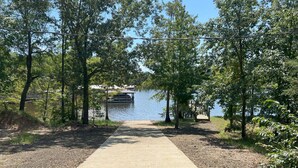 A gravel path leading to a dock by a lake, surrounded by trees. - Leisure Lake Cabin, Toledo Bend Lake (Many)