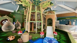 A children's play area with a treehouse, slides, and various play structures. - Spring Lodge with private hot tub (Hoburne Holiday Park)