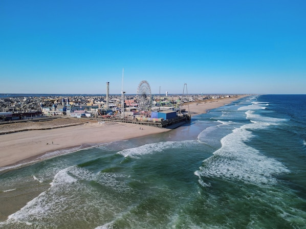 Enjoy a family-friendly beach day with a Ferris wheel, roller coaster, and carousel along the boardwalk.