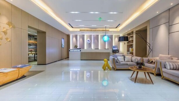 A modern lobby with a reception desk, seating area, and a visible staircase. - Rest Comfort Hotel (Wenzhou Lucheng) (Wenzhou)