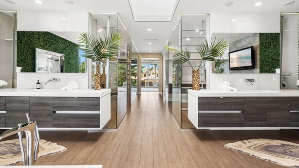A modern bathroom with two sinks, glass partitions, and a large mirror. - Villa Seminole: Luxurious Waterfront Retreat with Pool, Gym & Hot Tub (Fort Lauderdale)