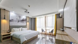 A modern hotel room with a large bed, a desk, and a dining area. - Century Business Hotel (Zuoling New Town) (Wuhan)