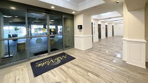 A hotel lobby with a chandelier, a reception desk, and a modern design. - MVG 1515 Penthouse 3 Bedroom 3 Bath Ocean View (North Myrtle Beach)