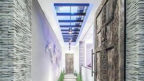 A modern hallway with a skylight, patterned walls, and a central pathway leading to a door. - Cozy 4 BR Modern Villa in Seminyak, Large Pool, Perfect and Fantastic (Kerobokan Kelod, Kec. Kuta Utara)