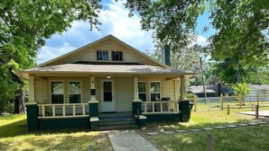 A single-story house with a front porch, a small front yard, and a pathway leading to the entrance. - Pet-Friendly 2BR | 2 Baths · Near Motor Speedway (Concord)
