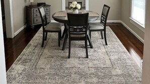 A dining room with a round table, four chairs, a rug, a clock, and a window with blinds. - Pet-Friendly 2BR | 2 Baths · Near Motor Speedway (Concord)