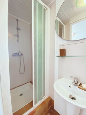 Shower, hair dryer, towels, toilet paper