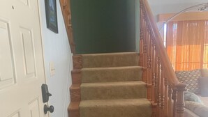 A carpeted staircase with wooden railings leading to a landing. - Riverfront 2 bed/2.5 bath Condo w/ Pool & Spa, River Dock - Small Dogs OK! (Bullhead City)