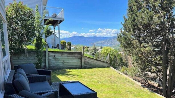 A patio with wicker furniture and a view of mountains. - Private 1bd 1 ba suite w/ lake views (Vernon)