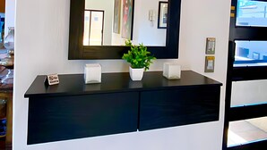 A modern bathroom with a large mirror, a potted plant, and a "No Smoking" sign. - Ajijic 2 Bedroom Unit-huge Patio-bikes-gym-pickleball Court-golf Cart-scooters (Chapala)