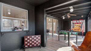 A modern room with a foosball table, a red and white board game, and a ceiling fan. - GameRoom, Trail access seconds away, cozy! (Bella Vista)
