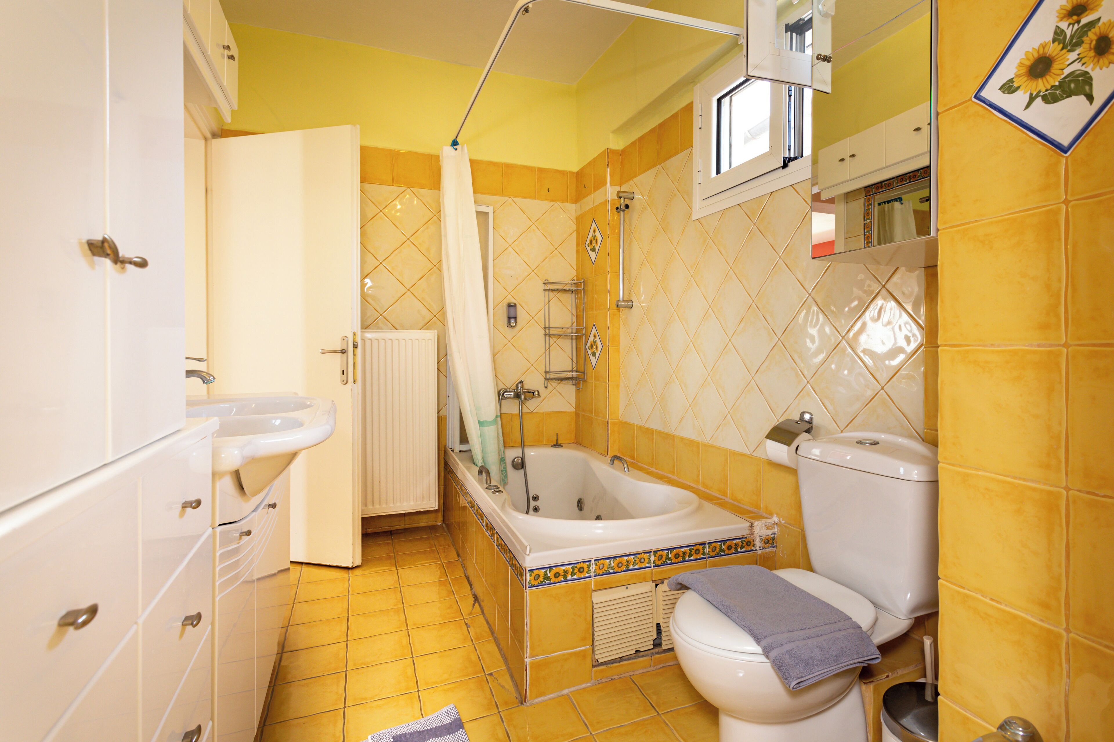 A bathroom with a bathtub, toilet, and sink.