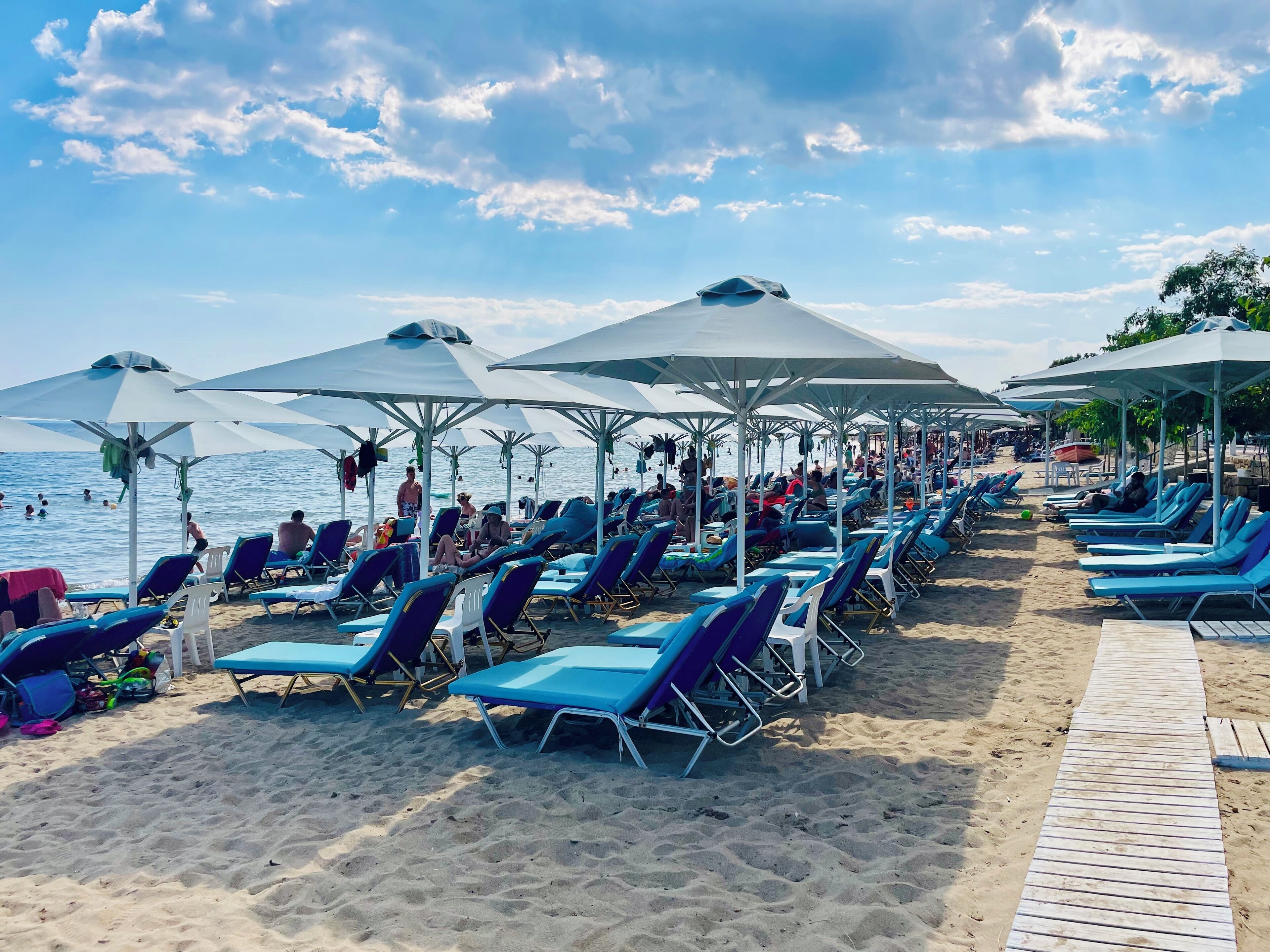 On the beach, white sand, sun loungers, beach umbrellas