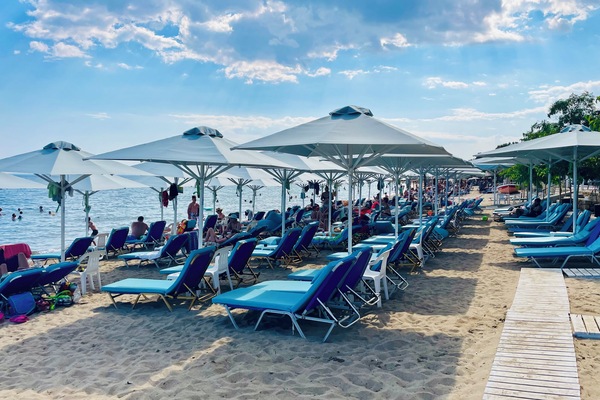 On the beach, white sand, sun loungers, beach umbrellas