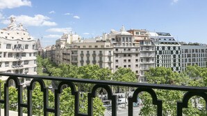 A cityscape with a variety of architectural styles, including a building with a unique curved facade and another with a flat roof. - Paseo de Gracia1 (Barcelona)