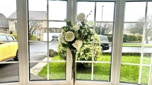 A bay window with a clear view of a street and parked cars. - Cosy Self Catering Family Home in a Quaint Village Setting (Wetherby)