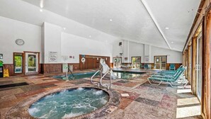 A large indoor pool area with a hot tub, lounge chairs, and a tiled floor. - Sleeps 8 Pool Playground Mountain Views Hot Tub (Gatlinburg)